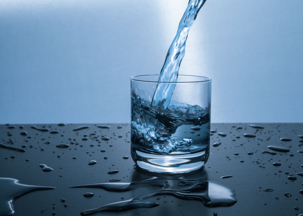 services-03 High-quality image of water being poured into a glass, illustrating hydration and purity.