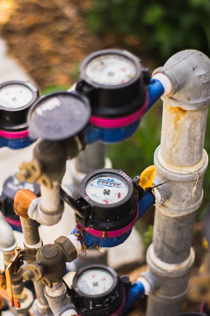 The Art of Drawing Readers In: Your attractive post title goes here A detailed view of multiple water meters connected by pipes in an industrial setting.